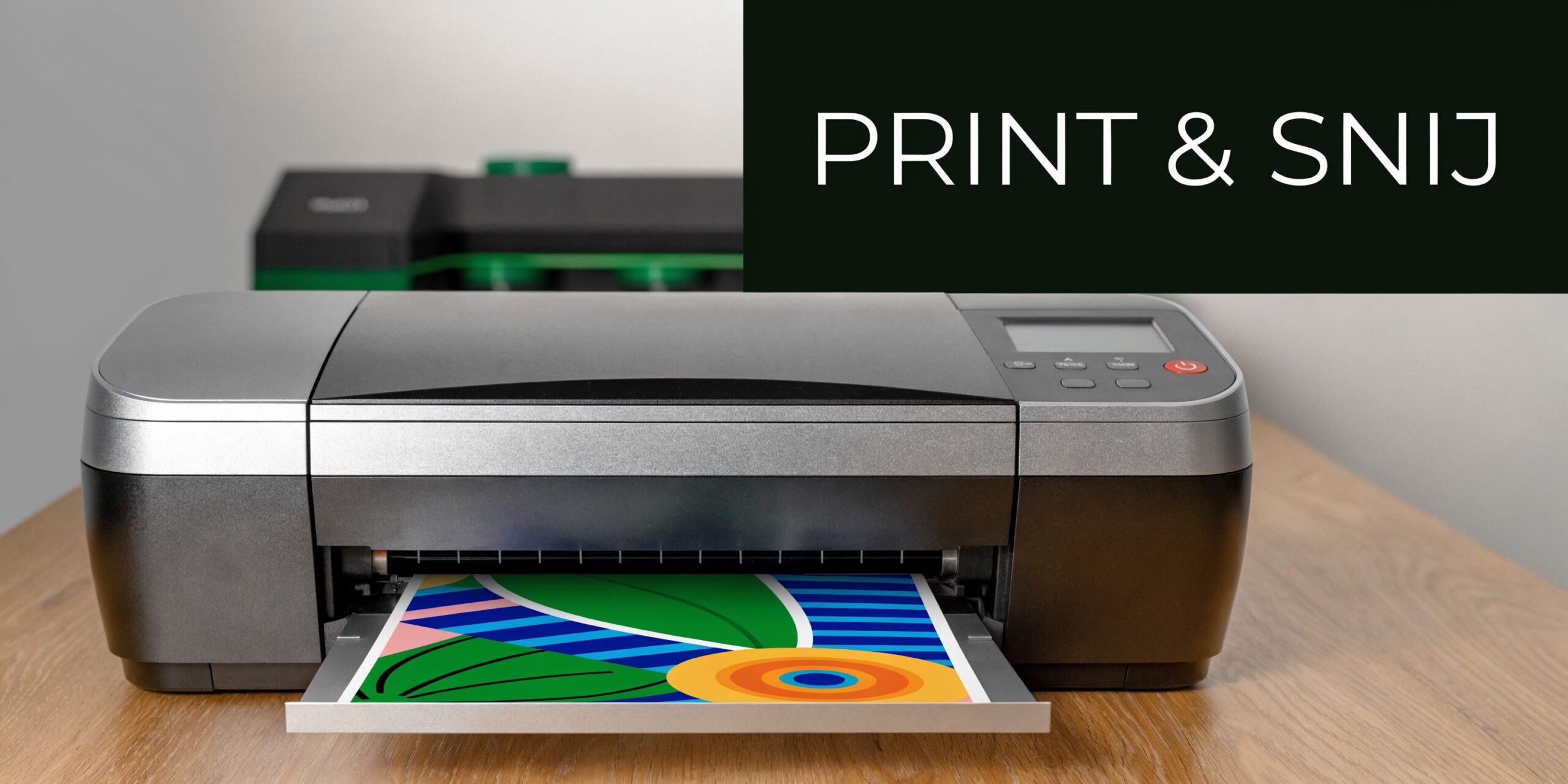 Een grijze printer op een houten tafel met een afdruk van een kleurrijk abstract ontwerp